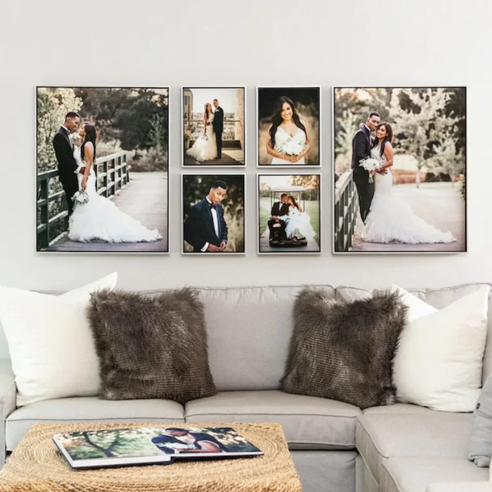 Wall gallery of custom wedding photo canvases above a grey sofa with fuzzy pillows