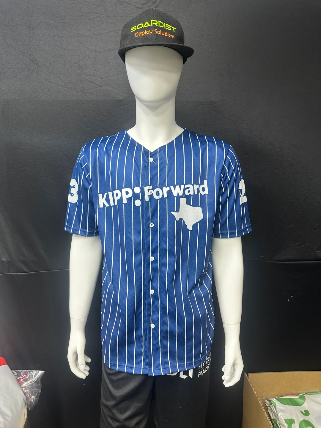 Custom blue pinstripe baseball jersey with KIPP Forward logo and Texas map on a mannequin