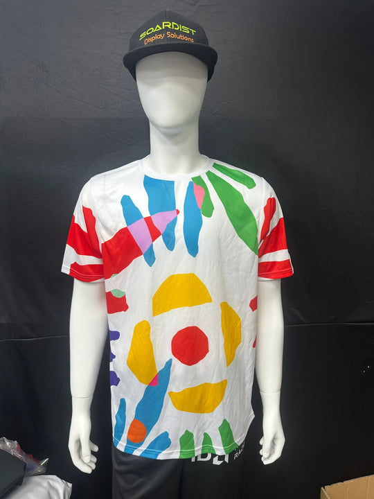 White custom printed t-shirt with colorful abstract shapes on a mannequin wearing a black cap