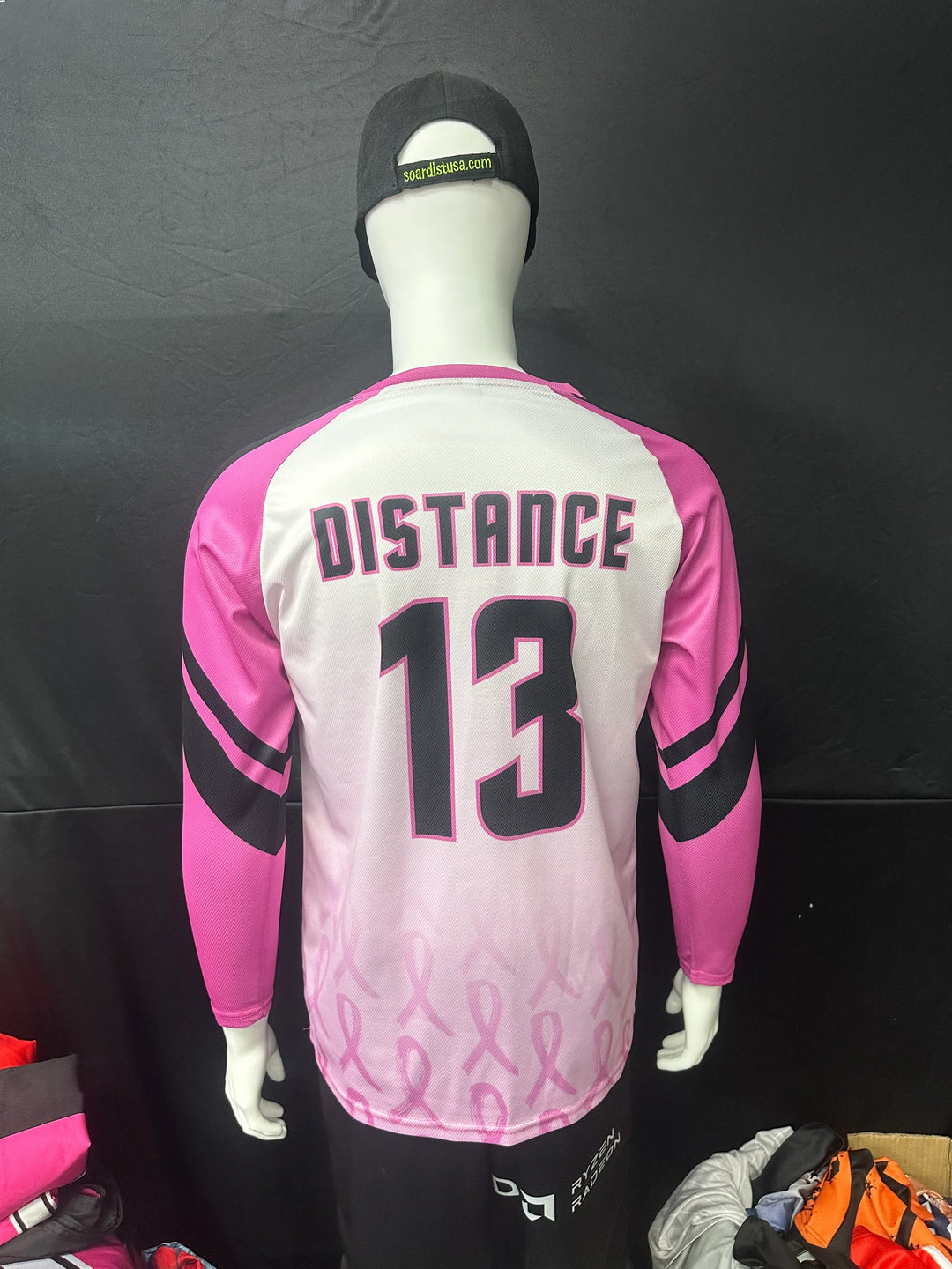 Custom white and pink long sleeve sports jersey with 'DISTANCE 13' printed on the back