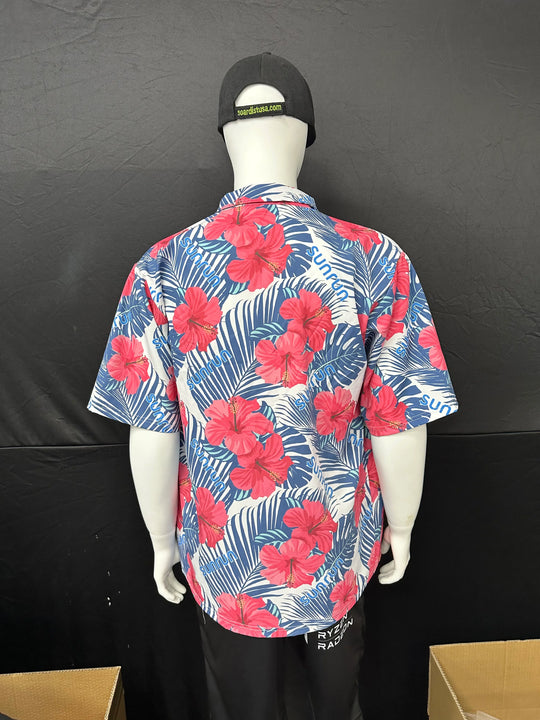 Back view of a mannequin wearing a blue short-sleeved shirt with red hibiscus floral print.