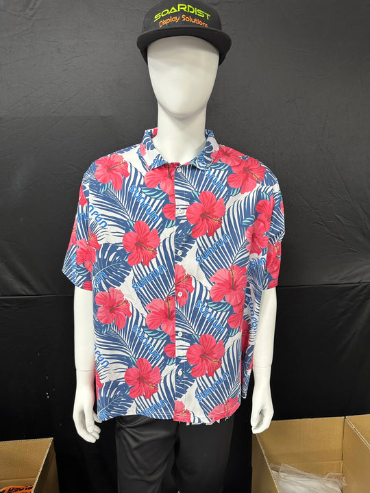 Mannequin wearing a white short-sleeve Hawaiian shirt with red hibiscus flowers and blue leaves.