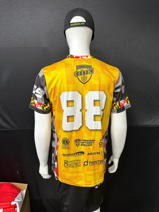 Custom yellow and grey soccer jersey with number 88 and sponsor logos on a mannequin