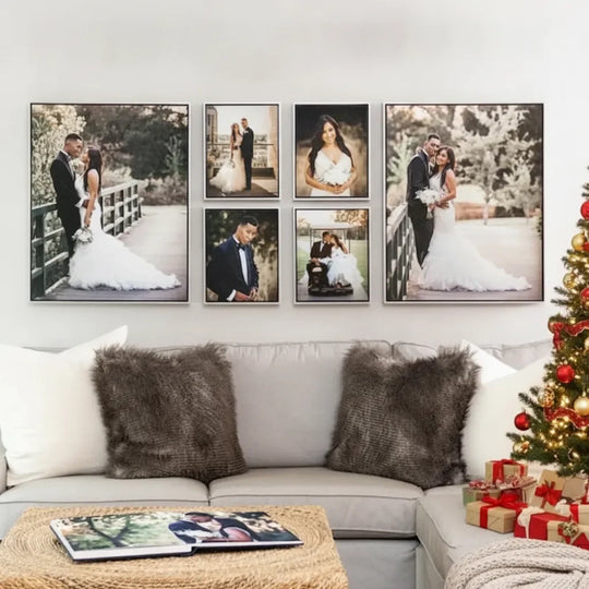 Gallery wall of custom wedding photo canvases above a grey sofa with fuzzy pillows