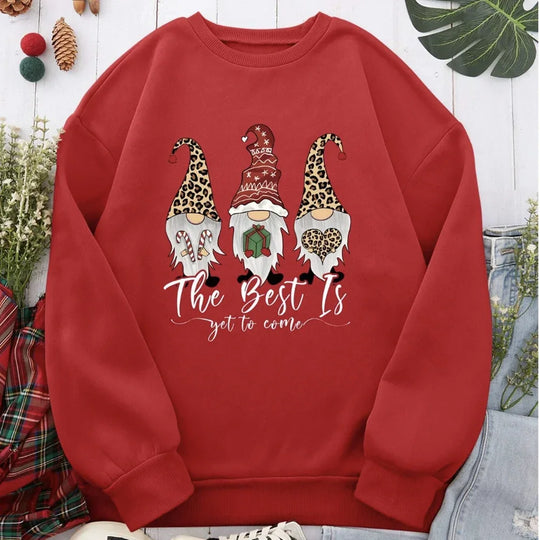 Red sweatshirt featuring three Christmas gnomes and 'The Best Is yet to come' text.