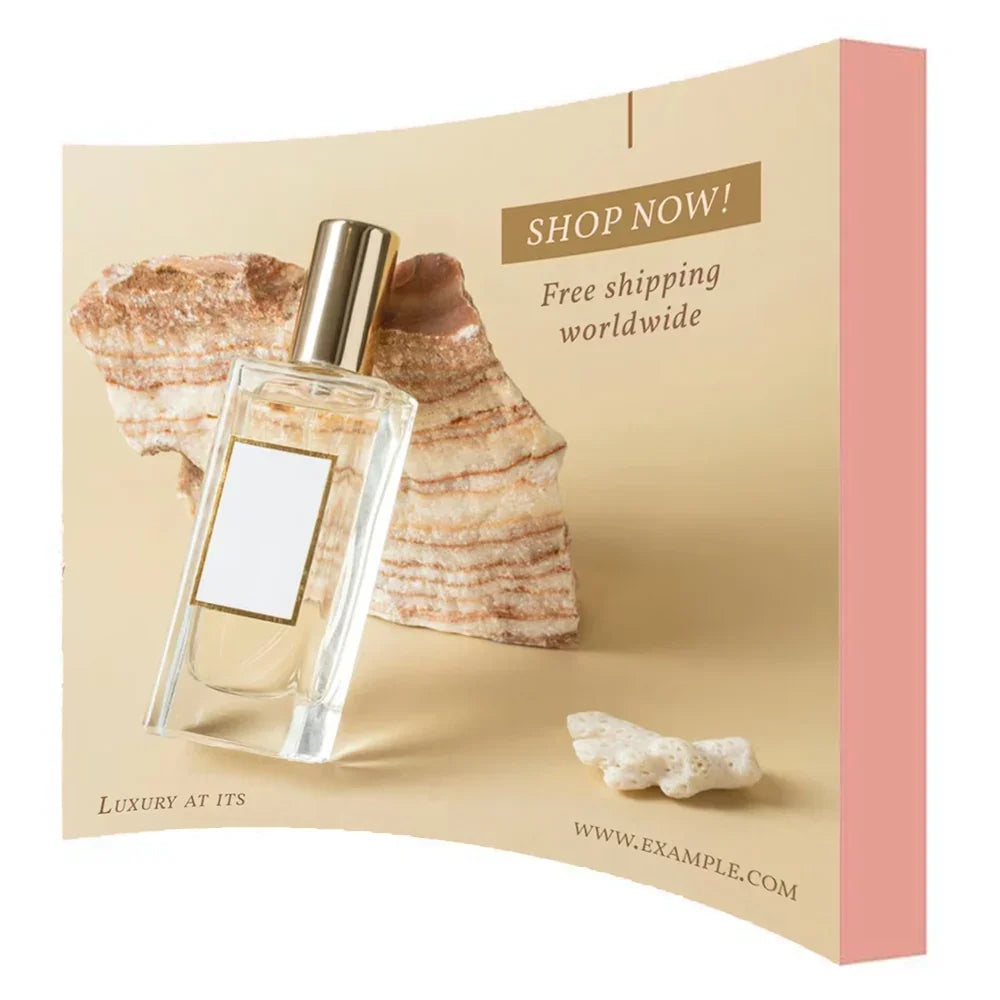 Elegant glass perfume bottle with gold cap placed against a textured stone background.