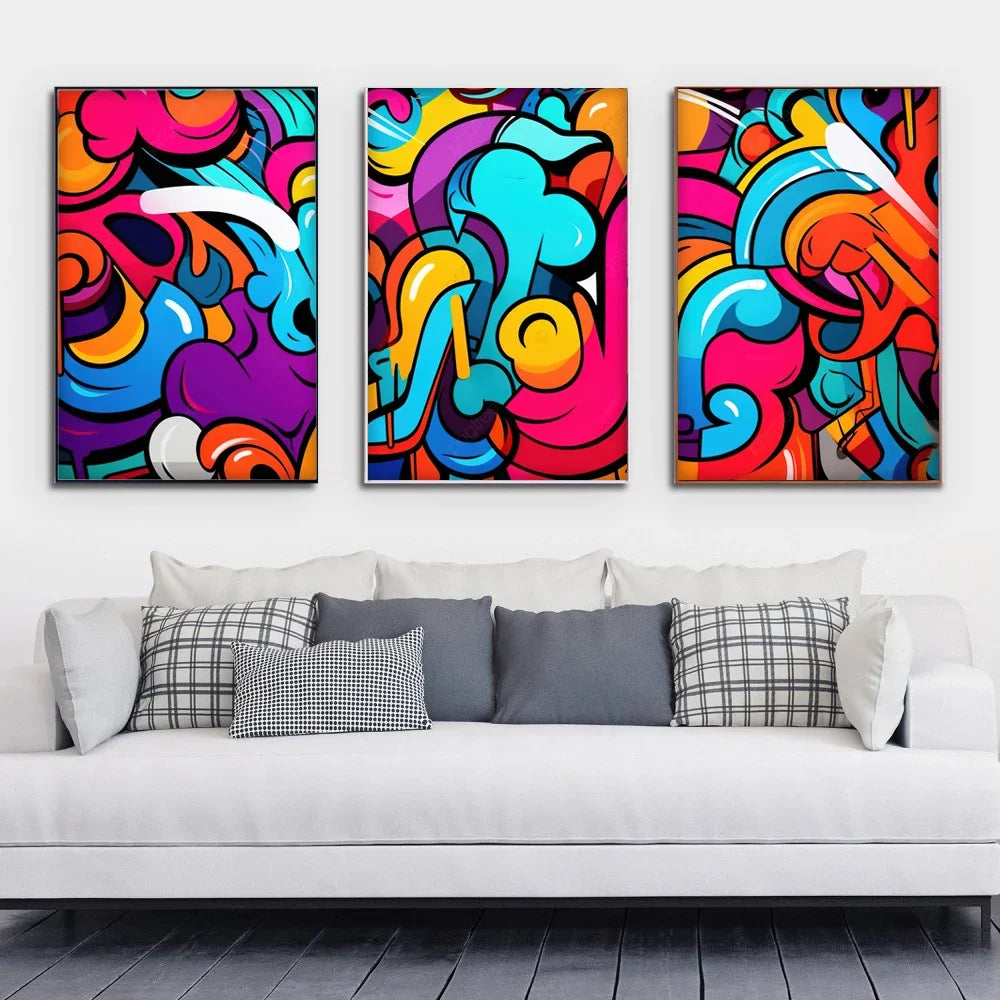 Three colorful abstract graffiti art canvases hanging above a white modern sofa.