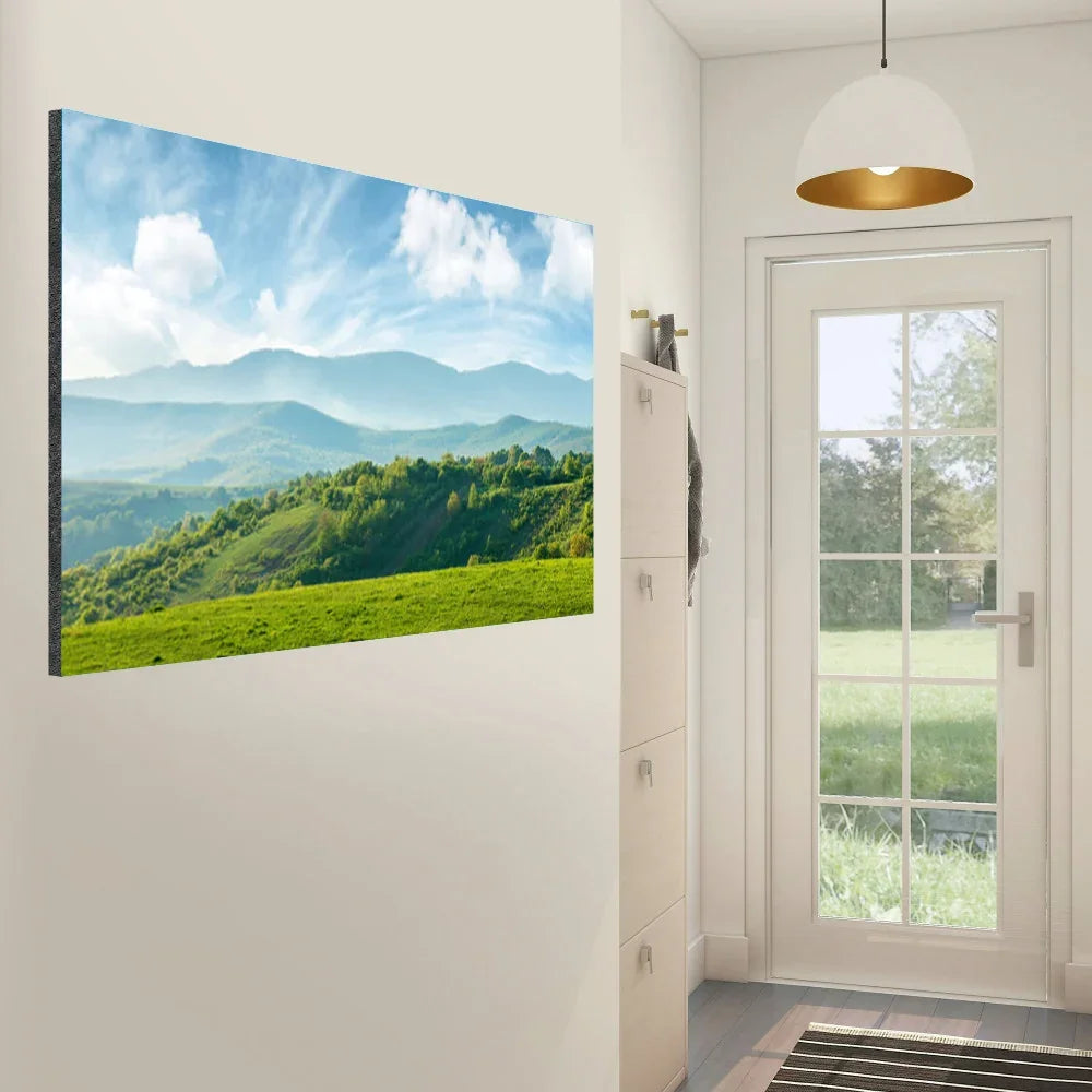 Canvas wall art featuring a lush green landscape with rolling hills and blue mountains