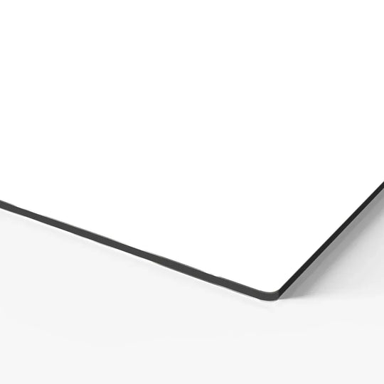 Close-up view of the corner of a white custom printed board with a black edge.