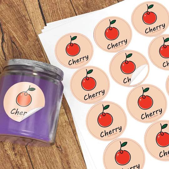 Custom cherry logo stickers on a sheet and applied to a purple jar.