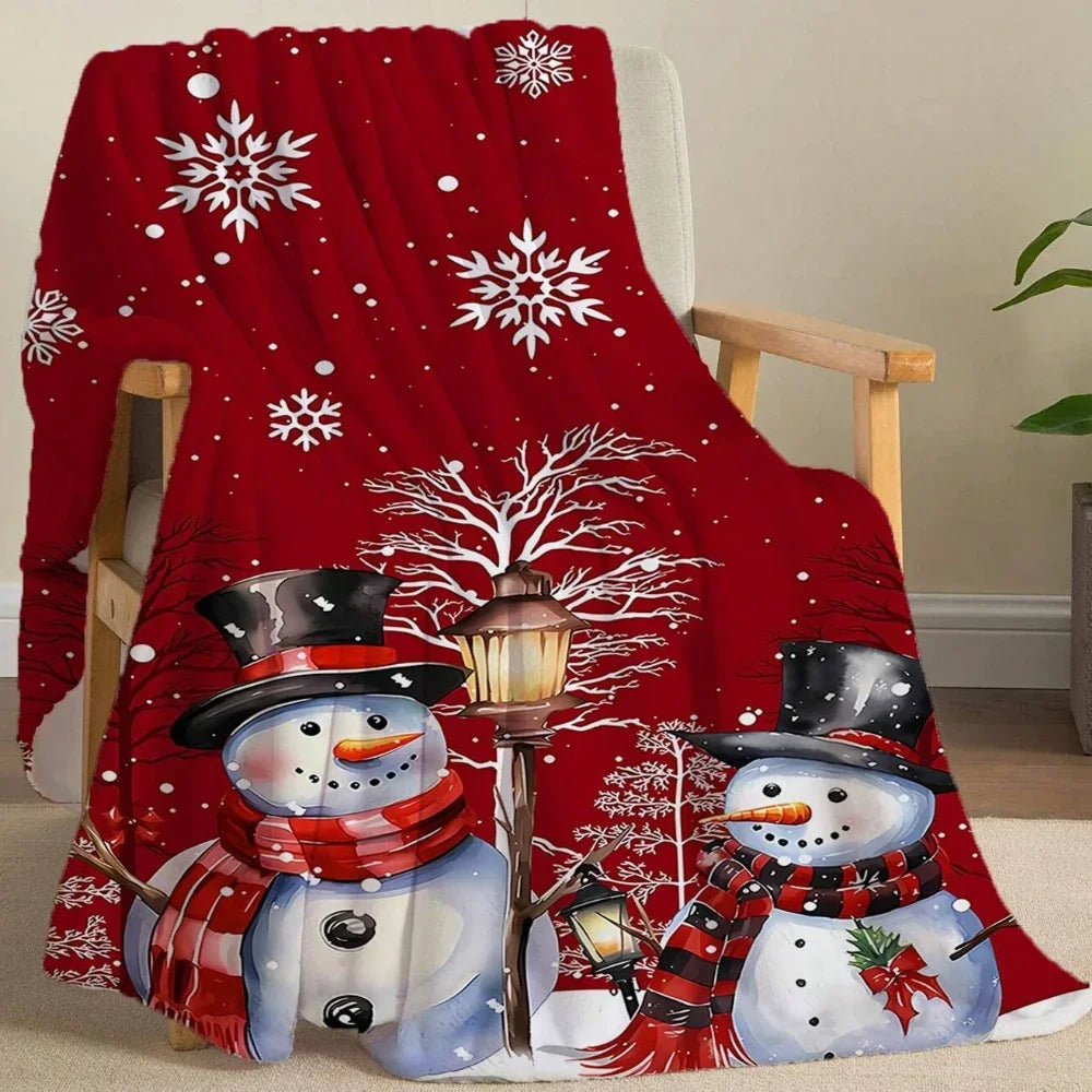 Red Christmas fleece blanket featuring two snowmen and white snowflakes