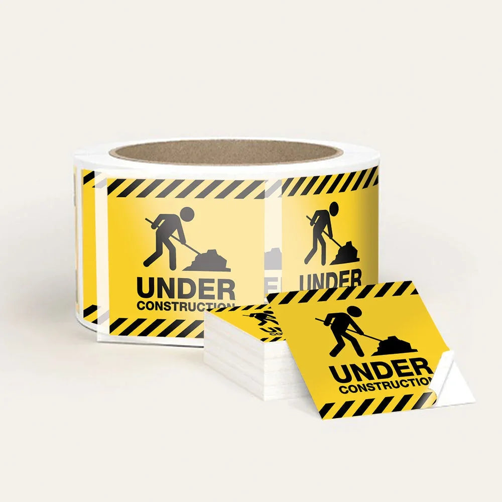 Roll and individual yellow Under Construction caution stickers with worker icon