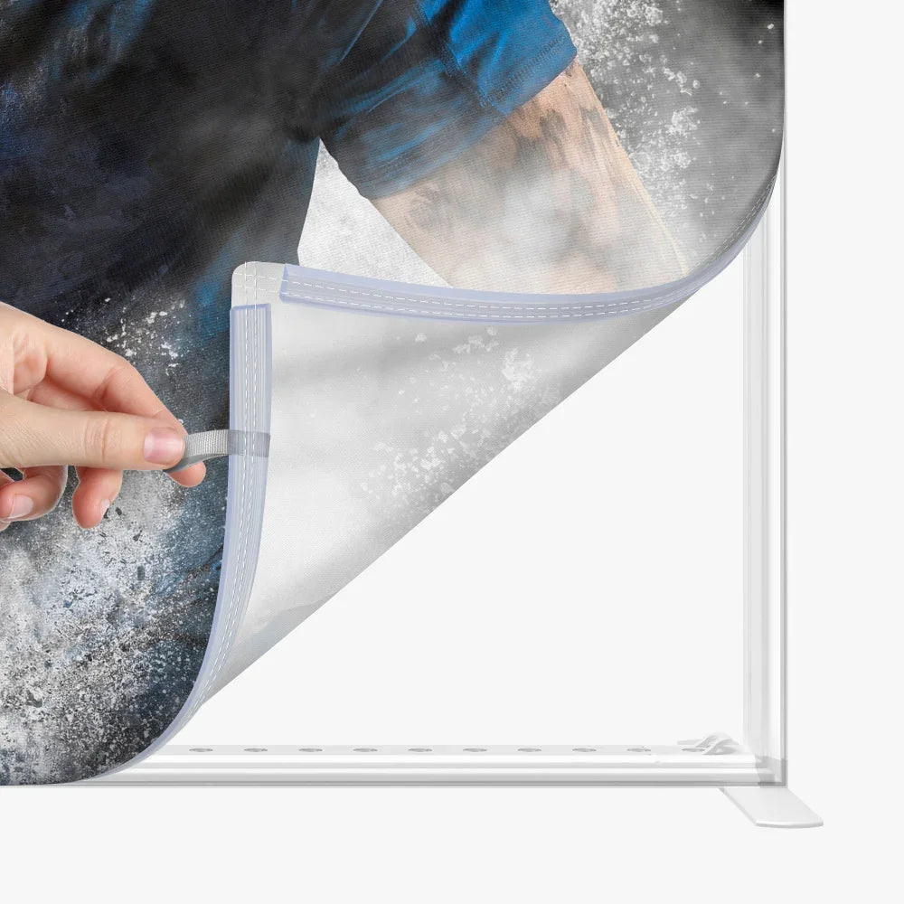 Close-up of a hand peeling back a clear protective film from a custom printed banner.