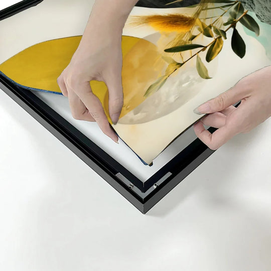 Hands peeling back a custom printed graphic from a black frame