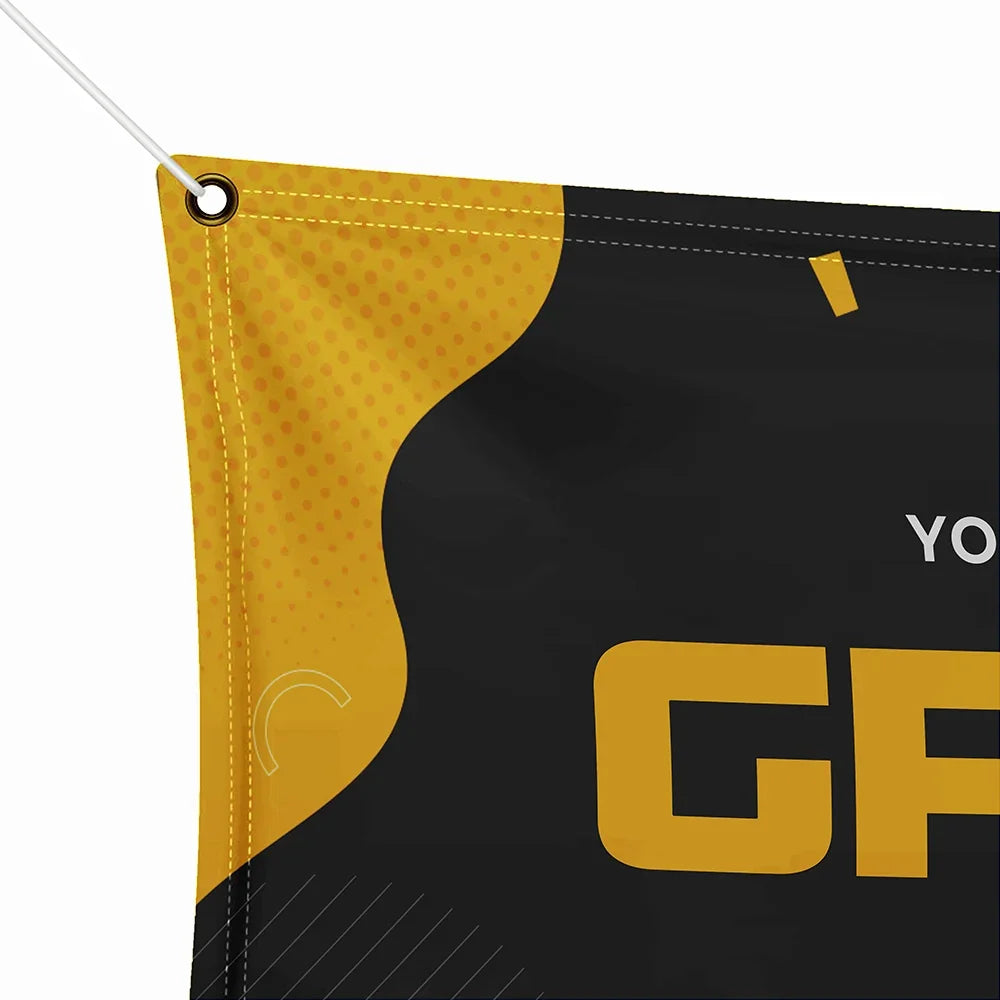 Close-up of a custom printed black and yellow flag with graphic text.