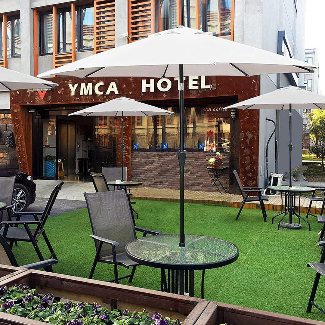 White patio umbrellas and outdoor seating area in front of a hotel