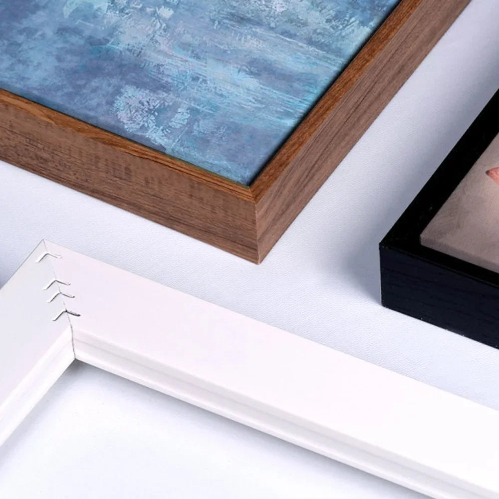 Close-up of wooden, black, and white picture frames showcasing different styles.