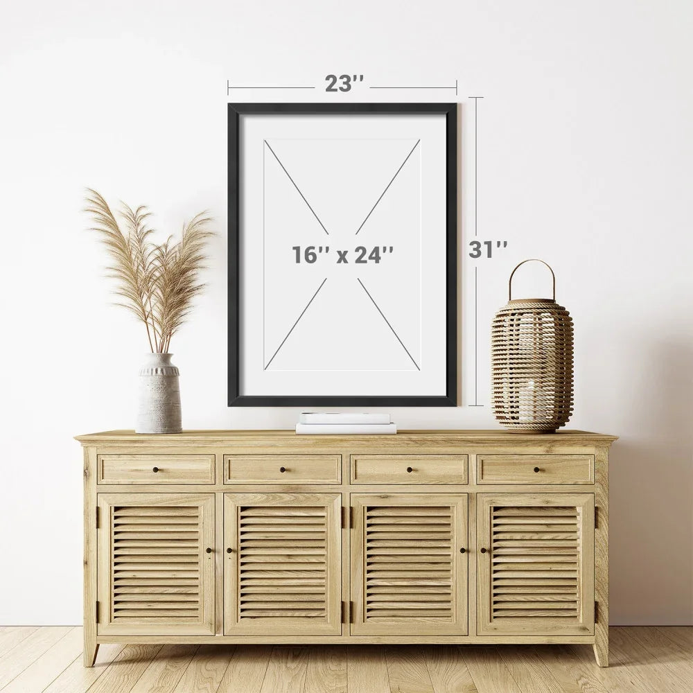 Black picture frame with 16x24 inch dimensions above a wooden sideboard cabinet