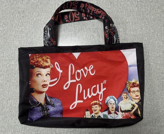 Black tote bag featuring 'I Love Lucy' graphics with images of Lucille Ball.