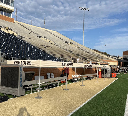 Custom Wake Forest Demon Deacons event tent set up on a stadium sideline.