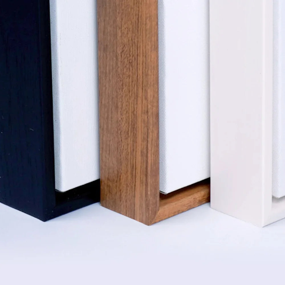 Close-up of black, wood, and white canvas frame options for custom banners