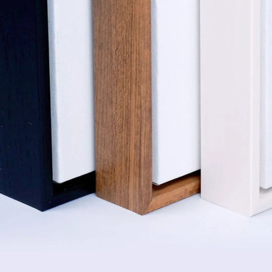 Close-up of black, wood, and white canvas frame options for custom banners