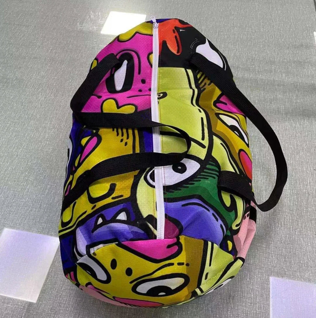 Colorful duffel bag with a vibrant, psychedelic cartoon print and black straps.